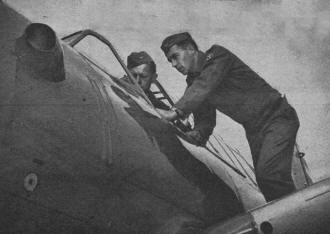 Flying Cadets A. L Nelson and V. K. White inspect a North American BT-9 - Airplanes and Rockets