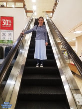 Melanie on the escalator in Sears at Friendly Center - Airplanes and Rockets