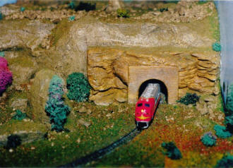 The Blattenbergers' N-Gauge Train Layout, Exiting the Tunnel - Airplanes and Rockets
