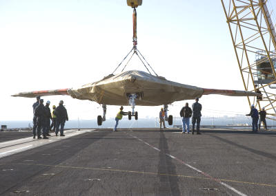 X-47B Being Lowered onto Deck of the USS Harry S. Truman -(U.S. Navy photo) - Airplanes and Rockets (business name: Kirt Blattenberger)