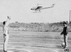 Yuji Oki, skillfully flies his helicopter slowly into the waiting hands of his helper - Airplanes and Rockets
