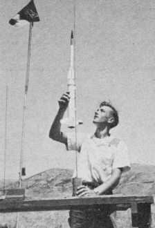 Joe Wald loads scale 2-stage miniature Cooper-Marquardt ASPAN sounding rocket at NARAM-3 - Airplanes and Rockets