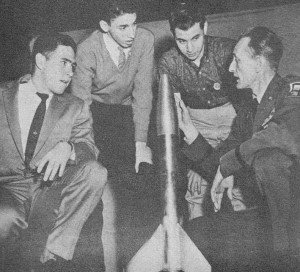 Capt. Brinley examines 3' high, 4" diameter model from Brooklyn - Airplanes and Rockets
